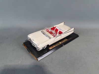 an image of a model of a white car on a black stand