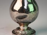 a silver vase that is sitting on a table
