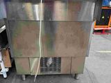 an image of a stainless steel counter top freezer in a warehouse
