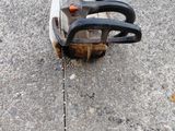a chainsaw on the ground with a chain attached to it