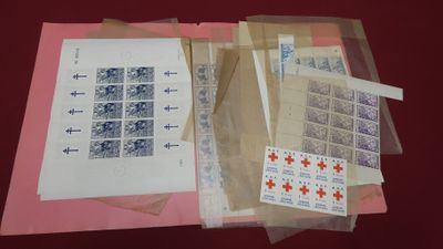 a lot of stamps on a table with a sheet of paper
