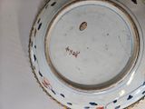a white plate with a blue and red design on it