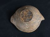 a close up of a clay bowl on a black surface