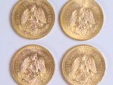 four gold coins with the image of a woman and a man on them
