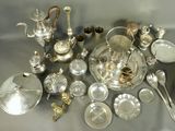 a lot of silver and silverware on a table