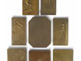 six antique brass plaques of a man and a woman