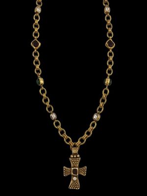a gold necklace with a cross pendant and a chain