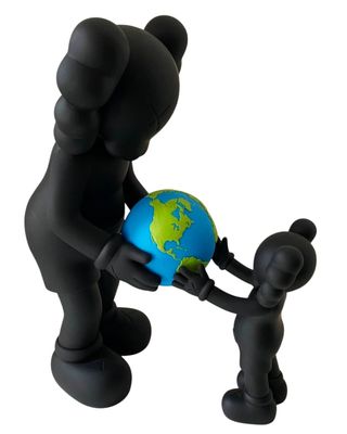 a small statue of a person holding a small globe