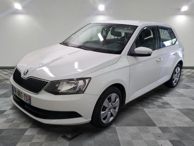 the white car is parked in the room on the checkered floor