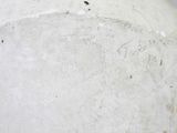 a close up of a white vase on a table
