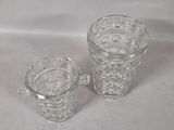 two glass cups sitting next to each other on a table