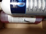 a bottle of liquid sitting in a box on the floor
