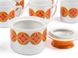 six cups and a saucer on a white table