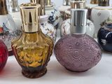 many different colored glass vases sitting on a table