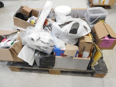 a pile of assorted items on a pallet in a warehouse