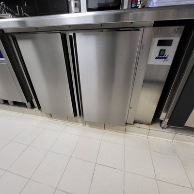 une rangée de portes en acier inoxydable dans des toilettes publiques