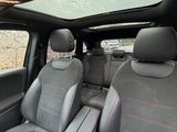 two seats in the back of a car with a sunroof