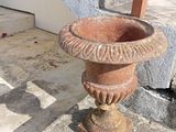 a stone urn sitting on the steps of a building