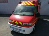 a red van with yellow and red stripes parked in front of a building
