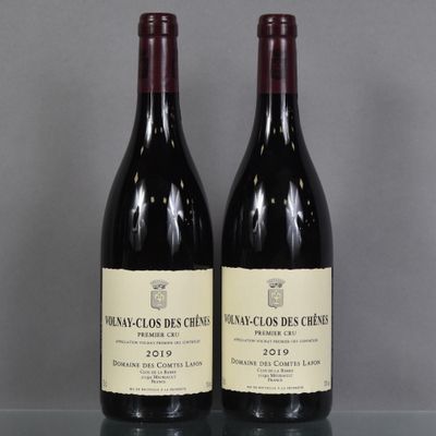two bottles of wine sitting on top of a table next to each other