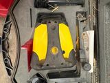 a yellow and black object in a case on the ground