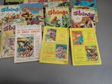 a lot of comic books that are on the table