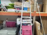 a ladder that is leaning against a wall in a warehouse