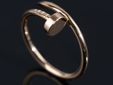 a close up of a gold ring on a black surface