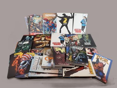a pile of comic books sitting on a table