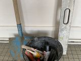 a bucket with tools in it sitting on the floor