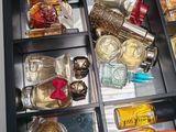 a drawer with many different types of perfumes in it