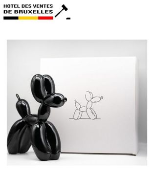 the black balloon dog is next to a white box with a drawing of a dog on it