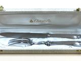 a silver box with a knife and fork inside of it