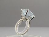 an image of a ring with a blue topaz stone in it