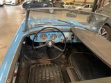 a blue and black car inside of a garage