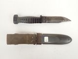 two knives are laying next to each other on a white surface