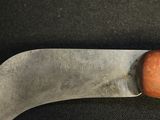 a close up of a knife on a black surface
