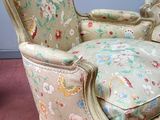 a chair with a floral upholstered cushion on it