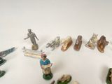 many figurines of people and animals on the table