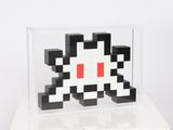 a black and white cube with a red dot on it