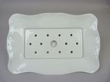 a picture of a white plate with holes in it
