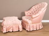 a pink chair and ottoman sitting on a wooden floor