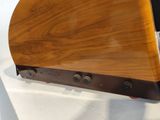 a small wooden object on display on a white surface