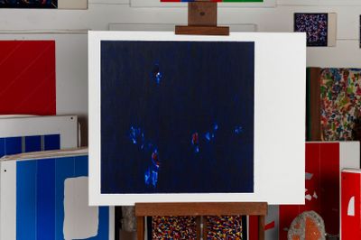 a picture of a painting on a easel in a room