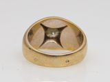 a close up of a gold ring with a diamond in the center