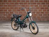 a motorcycle that is parked in front of a brick wall
