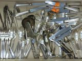 a box full of silver spoons and forks in it