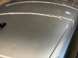 a close up of a car ' s hood with a remote control on it