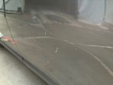 a close up of a car ' s side door with bullet holes