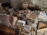 a bed that has a lot of books on it